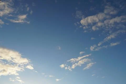 White fluffy clouds in the sky. Blue sky and cloud cover on a sunny summer da 写真素材