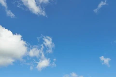 White fluffy clouds in the sky. Blue sky and cloud cover on a sunny summer da 写真素材
