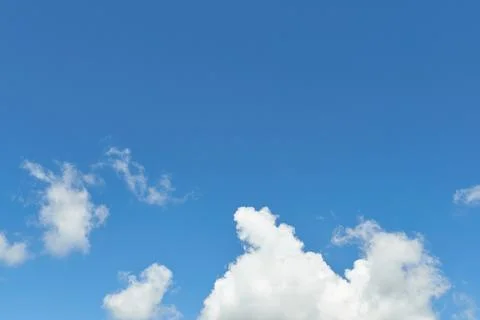 White fluffy clouds in the sky. Blue sky and cloud cover on a sunny summer da 写真素材