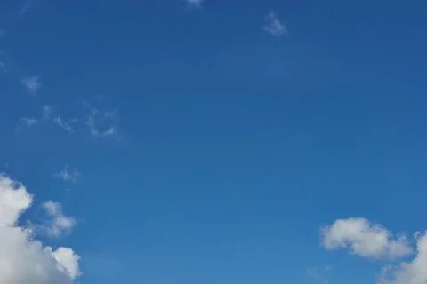 White fluffy clouds in the sky. Blue sky and cloud cover on a sunny summer da 写真素材