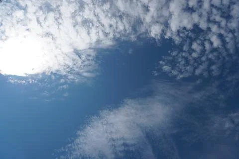 White fluffy clouds in the sky. Blue sky and cloud cover on a sunny summer da Stock Photos