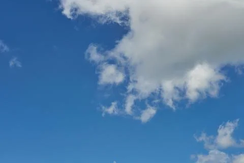 White fluffy clouds in the sky. Blue sky and cloud cover on a sunny summer da 写真素材