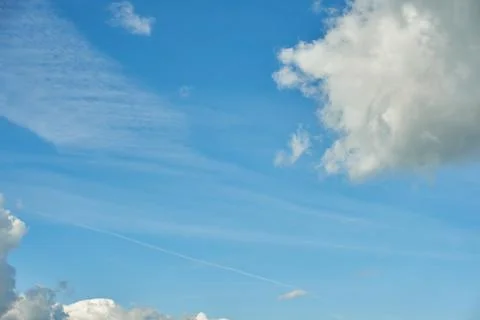 White fluffy clouds in the sky. Blue sky and cloud cover on a sunny summer da 写真素材