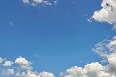 White fluffy clouds in the sky. Blue sky and cloud cover on a sunny summer da 写真素材