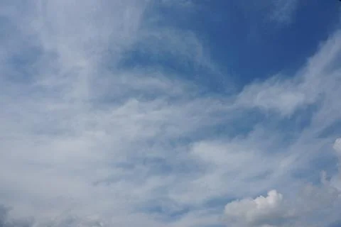 White fluffy clouds in the sky. Blue sky and cloud cover on a sunny summer da 写真素材