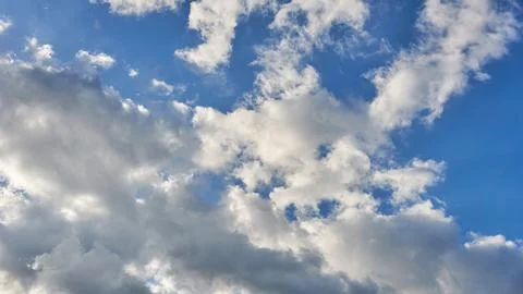 White fluffy clouds in the sky. Blue sky and cloud cover on a sunny summer da 写真素材