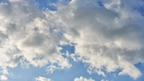 White fluffy clouds in the sky. Blue sky and cloud cover on a sunny summer da 写真素材