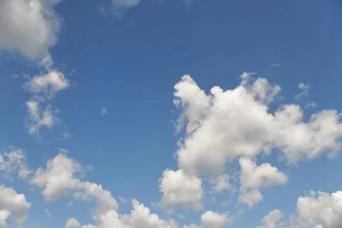 White fluffy clouds in the sky. Blue sky and cloud cover on a sunny summer da 写真素材