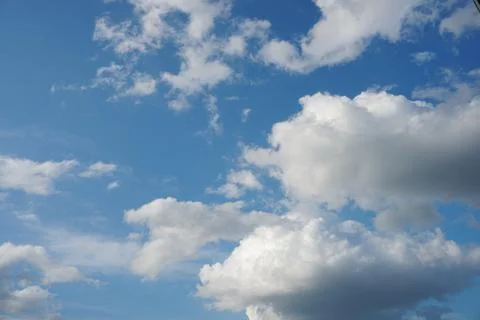 White fluffy clouds in the sky. Blue sky and cloud cover on a sunny summer da 写真素材