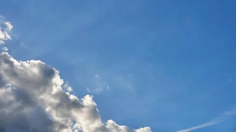 White fluffy clouds in the sky. Blue sky and cloud cover on a sunny summer da 写真素材