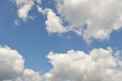 White fluffy clouds in the sky. Blue sky and cloud cover on a sunny summer da 写真素材