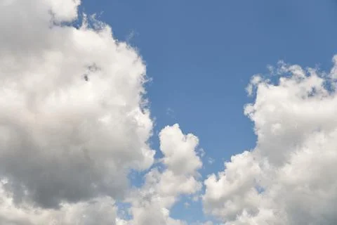 White fluffy clouds in the sky. Blue sky and cloud cover on a sunny summer da 写真素材