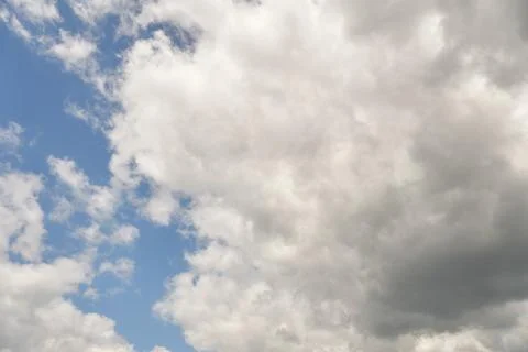 White fluffy clouds in the sky. Blue sky and cloud cover on a sunny summer da Stock Photos