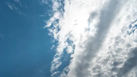 White fluffy clouds in the sky. Blue sky and cloud cover on a sunny summer da 写真素材