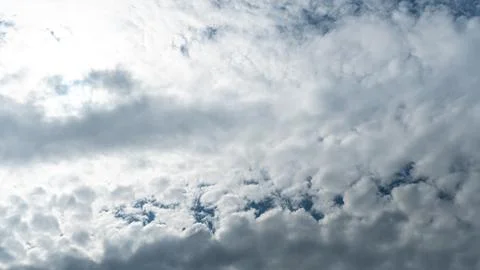 White fluffy clouds in the sky. Blue sky and cloud cover on a sunny summer da Stock Photos
