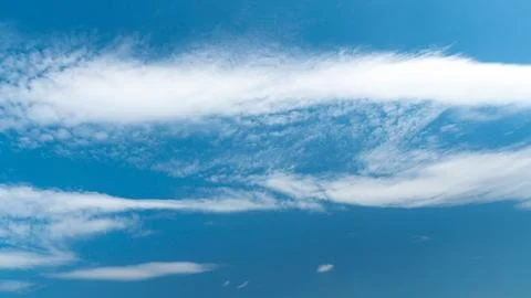 White fluffy clouds in the sky. Blue sky and cloud cover on a sunny summer da 写真素材