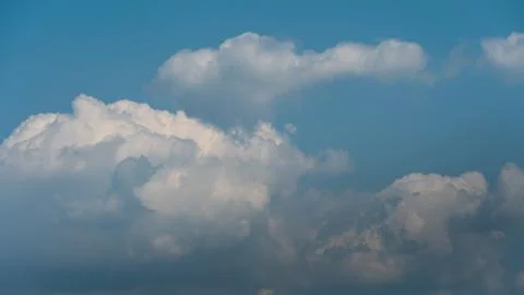 White fluffy clouds in the sky. Blue sky and cloud cover on a sunny summer da 写真素材