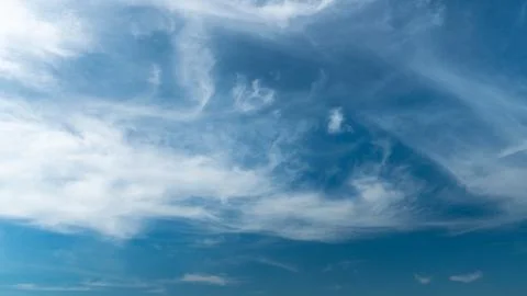 White fluffy clouds in the sky. Blue sky and cloud cover on a sunny summer da Stock Photos