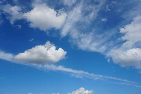 White fluffy clouds in the sky. Blue sky and cloud cover on a sunny summer da 写真素材