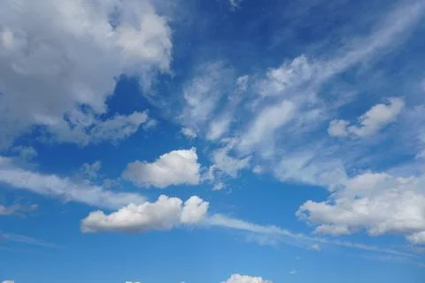 White fluffy clouds in the sky. Blue sky and cloud cover on a sunny summer da 写真素材