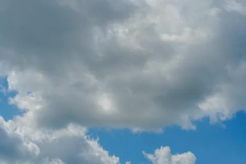 White fluffy clouds in the sky. Blue sky and cloud cover on a sunny summer da 写真素材