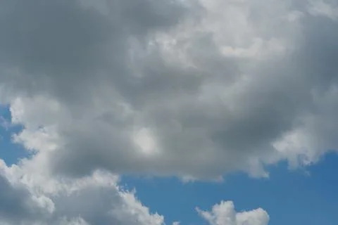 White fluffy clouds in the sky. Blue sky and cloud cover on a sunny summer da 写真素材