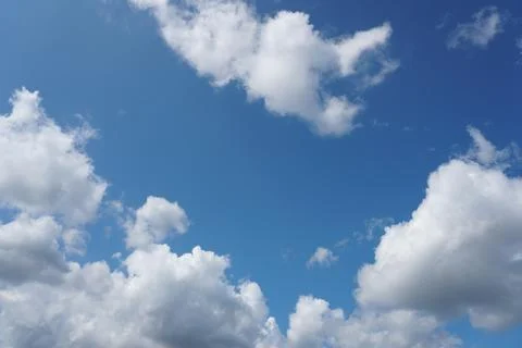White fluffy clouds in the sky. Blue sky and cloud cover on a sunny summer da 写真素材