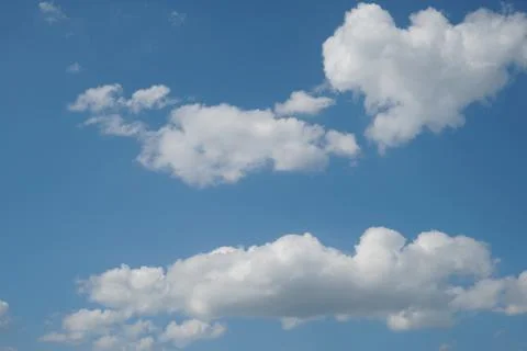 White fluffy clouds in the sky. Blue sky and cloud cover on a sunny summer da 写真素材
