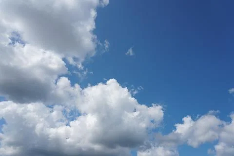 White fluffy clouds in the sky. Blue sky and cloud cover on a sunny summer da 写真素材
