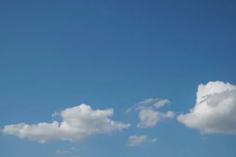 White fluffy clouds in the sky. Blue sky and cloud cover on a sunny summer da 写真素材