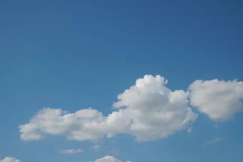 White fluffy clouds in the sky. Blue sky and cloud cover on a sunny summer da 写真素材