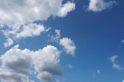 White fluffy clouds in the sky. Blue sky and cloud cover on a sunny summer da 写真素材