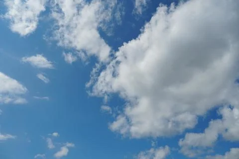 White fluffy clouds in the sky. Blue sky and cloud cover on a sunny summer da 写真素材