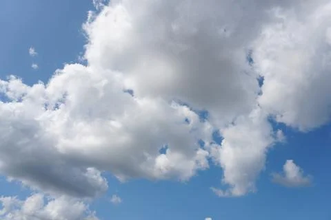 White fluffy clouds in the sky. Blue sky and cloud cover on a sunny summer da 写真素材