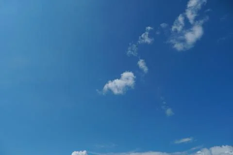 White fluffy clouds in the sky. Blue sky and cloud cover on a sunny summer da 写真素材