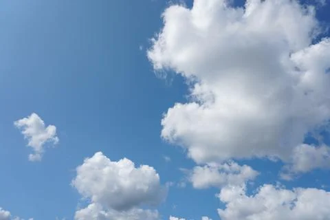White fluffy clouds in the sky. Blue sky and cloud cover on a sunny summer da 写真素材