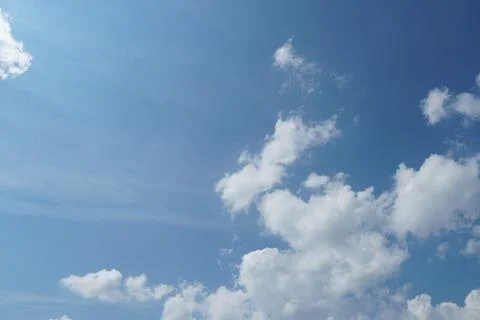 White fluffy clouds in the sky. Blue sky and cloud cover on a sunny summer da 写真素材