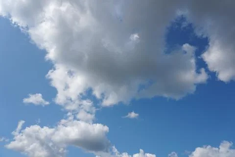 White fluffy clouds in the sky. Blue sky and cloud cover on a sunny summer da 写真素材