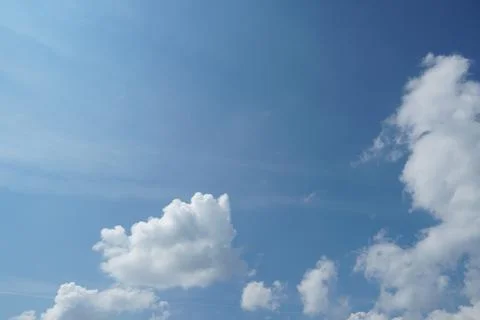 White fluffy clouds in the sky. Blue sky and cloud cover on a sunny summer da 写真素材