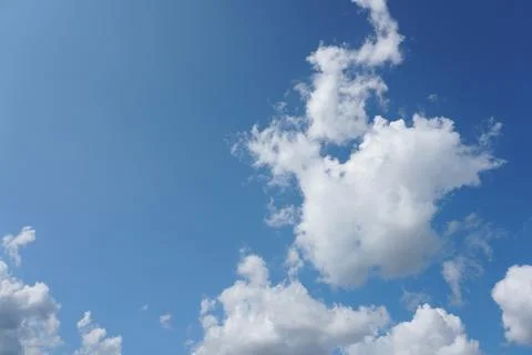 White fluffy clouds in the sky. Blue sky and cloud cover on a sunny summer da 写真素材