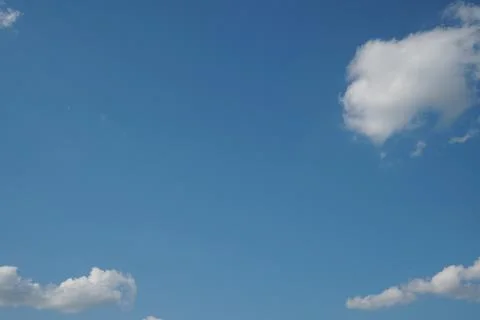White fluffy clouds in the sky. Blue sky and cloud cover on a sunny summer da 写真素材