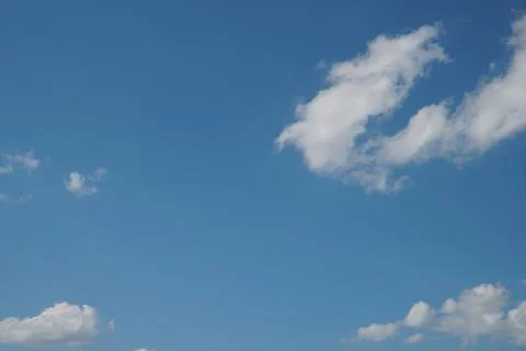 White fluffy clouds in the sky. Blue sky and cloud cover on a sunny summer da 写真素材