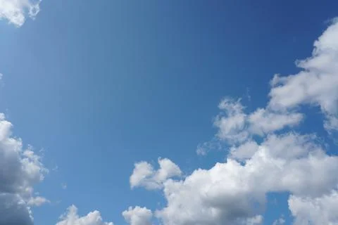 White fluffy clouds in the sky. Blue sky and cloud cover on a sunny summer da 写真素材