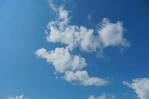 White fluffy clouds in the sky. Blue sky and cloud cover on a sunny summer da 写真素材