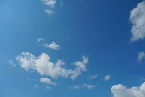White fluffy clouds in the sky. Blue sky and cloud cover on a sunny summer da 写真素材