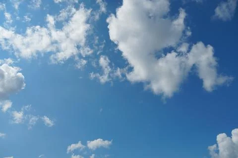 White fluffy clouds in the sky. Blue sky and cloud cover on a sunny summer da 写真素材