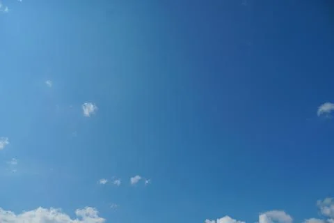 White fluffy clouds in the sky. Blue sky and cloud cover on a sunny summer da 写真素材