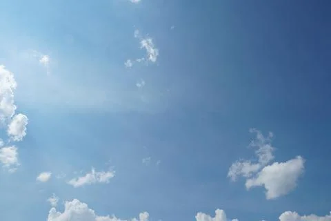White fluffy clouds in the sky. Blue sky and cloud cover on a sunny summer da 写真素材