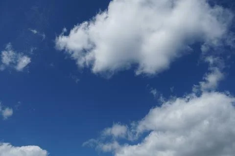 White fluffy clouds in the sky. Blue sky and cloud cover on a sunny summer da 写真素材