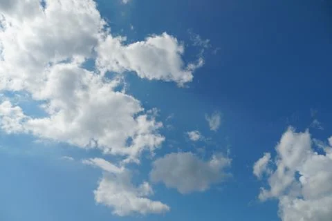 White fluffy clouds in the sky. Blue sky and cloud cover on a sunny summer da 写真素材
